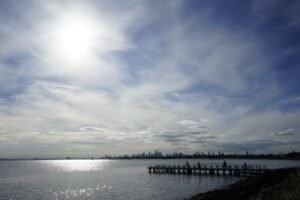 Melbourne skyline wall art - cityscape view across Port Phillip Bay with a wooden pier in the foreground near Elwood Beach